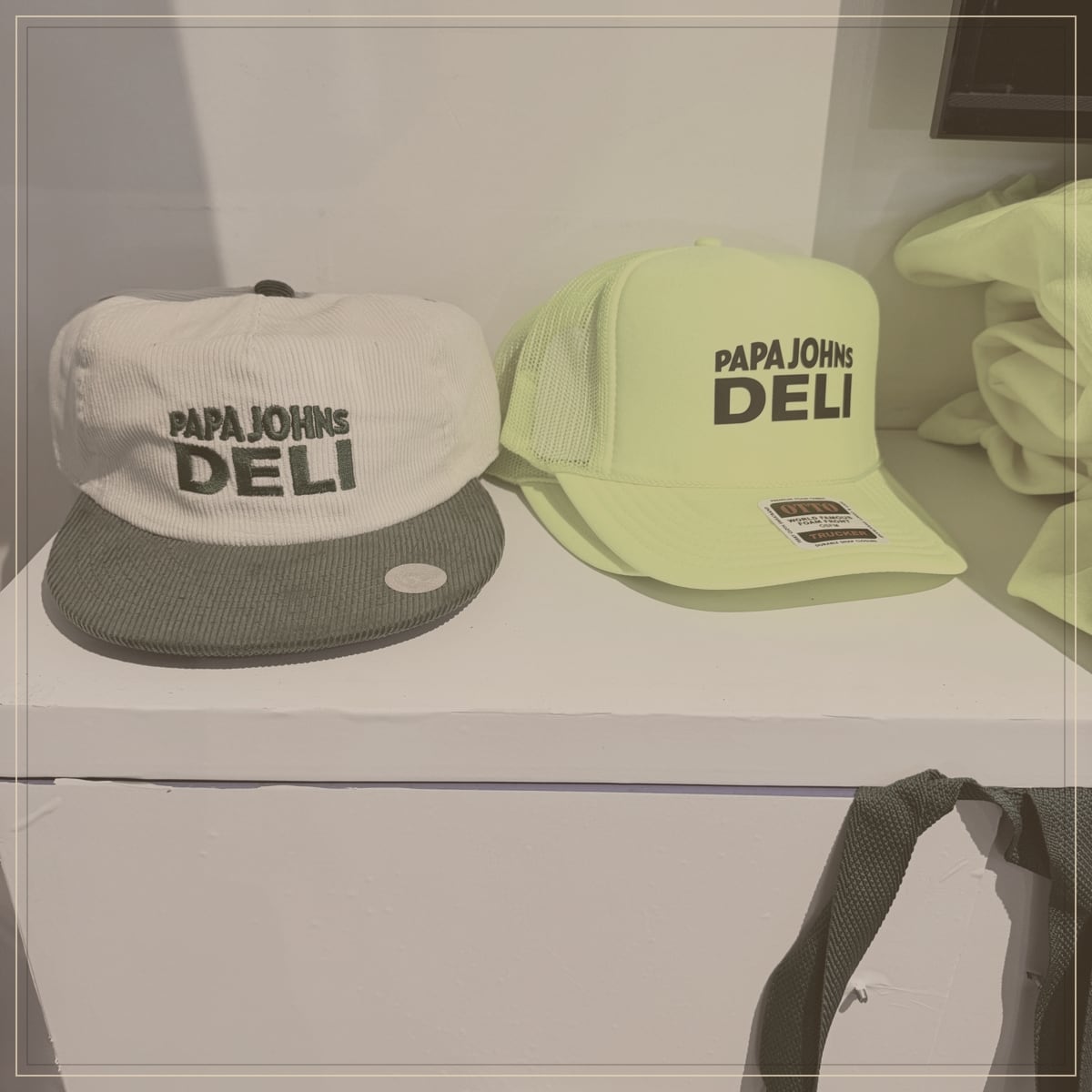 Embroidered corduroy and foam trucker caps displayed on a retail shelf as monogram bar samples
